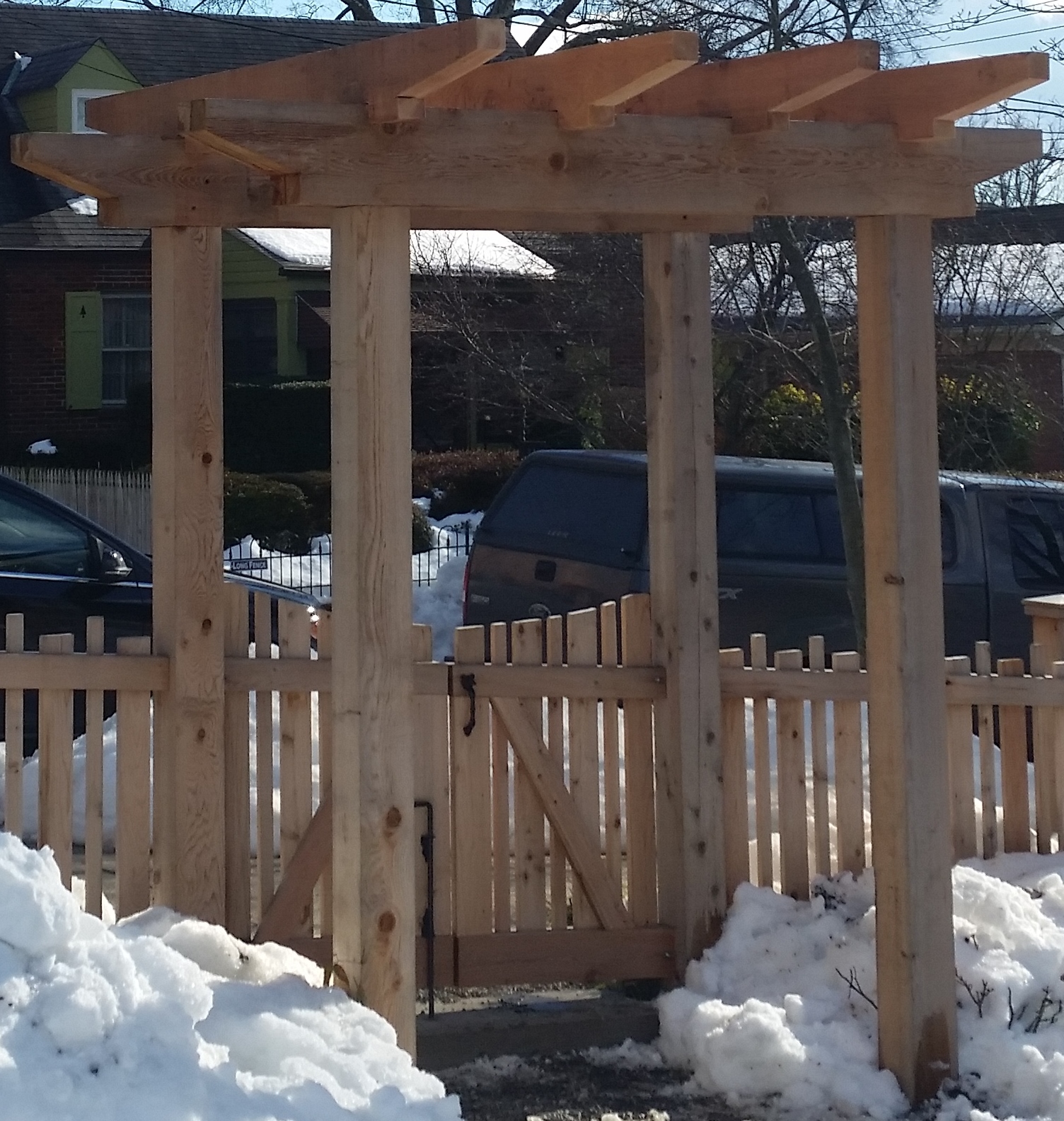 An Arbor/Pergola in Western Red Cedar over an Alternating Board Picket Double Gate