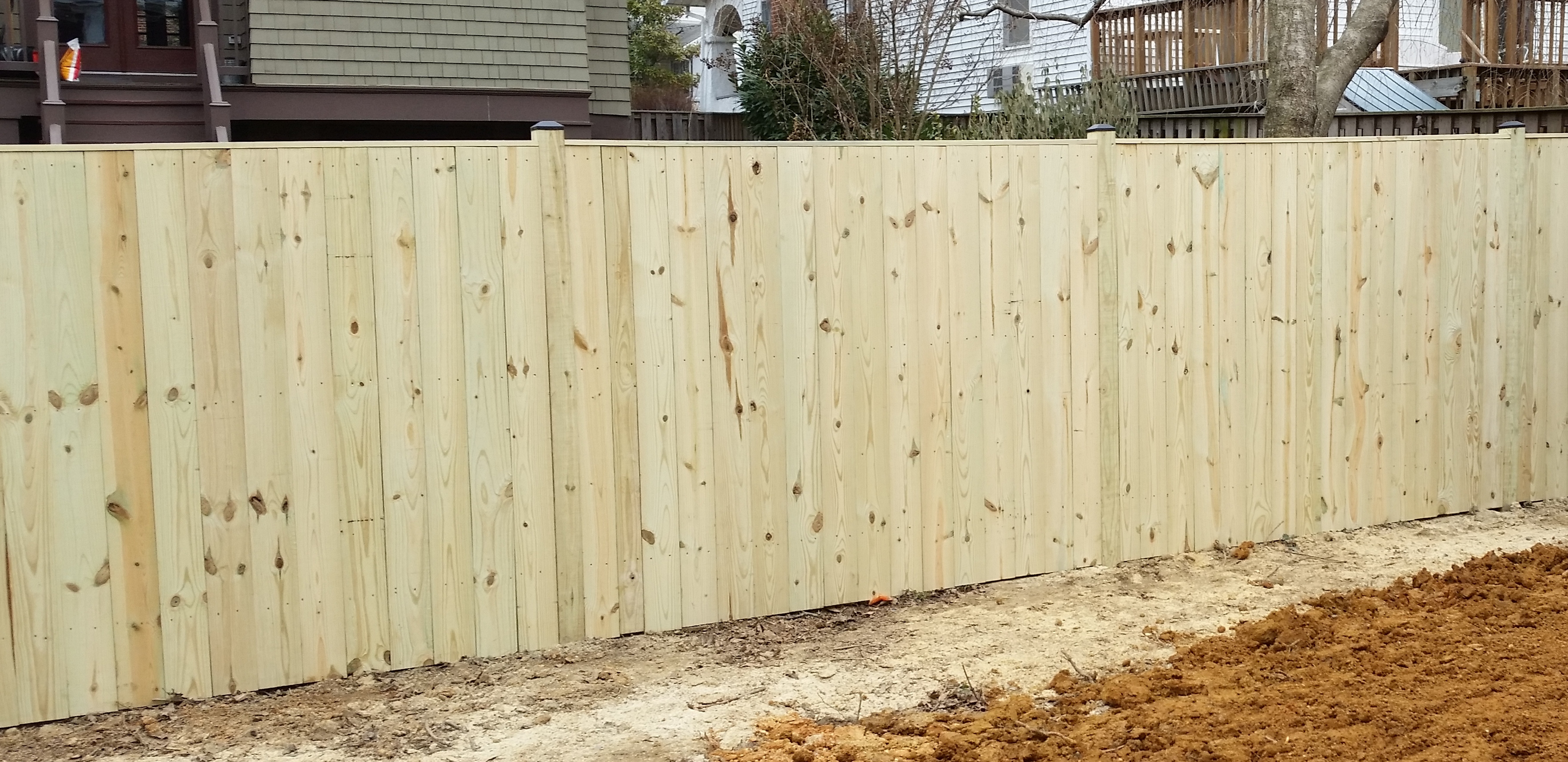Pressure Treated Fence With 2x4 Cap Board and Black Vinyl Post Caps