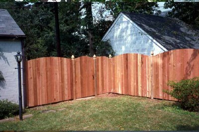 Western Red Cedar Flat Board Fence with Finial Posts and Arches Added.