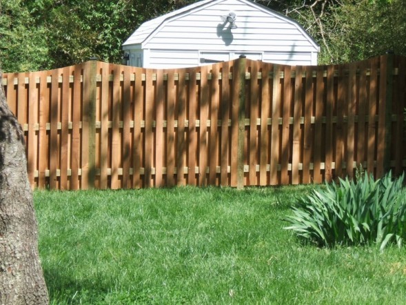 Western Red Cedar Alternating Board Fence with Black Vinyl Post Caps and Dips Added.