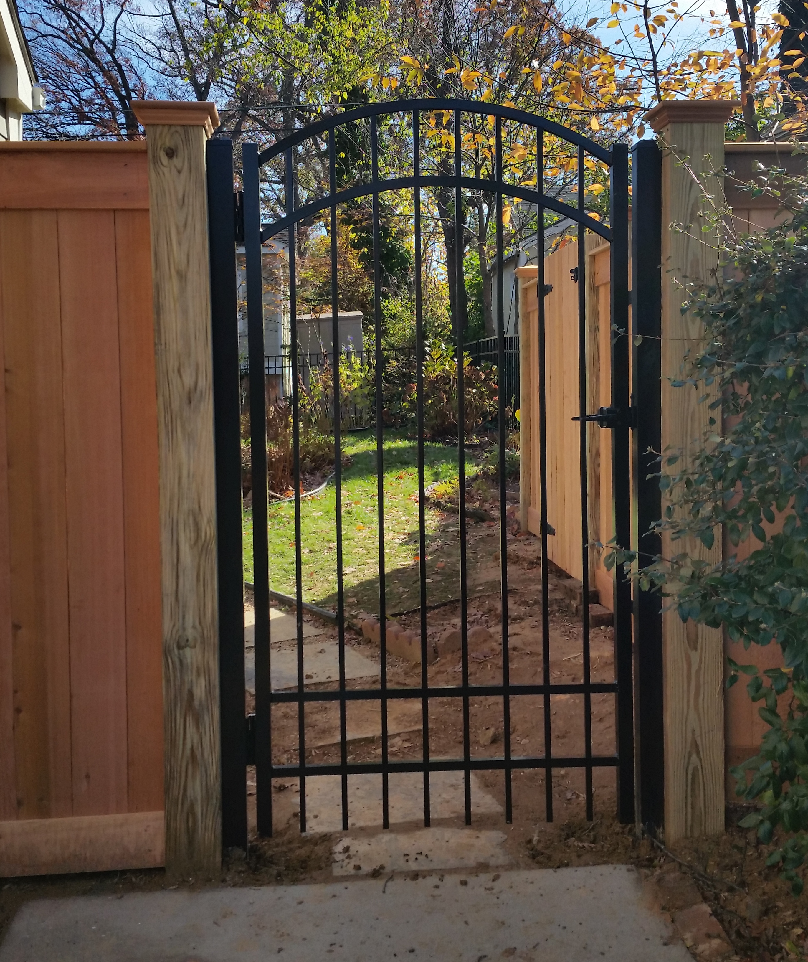 Black Aluminum Single Gate with Wood Fencing