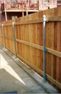 Special brackets are used to attach a wood fence to steel posts