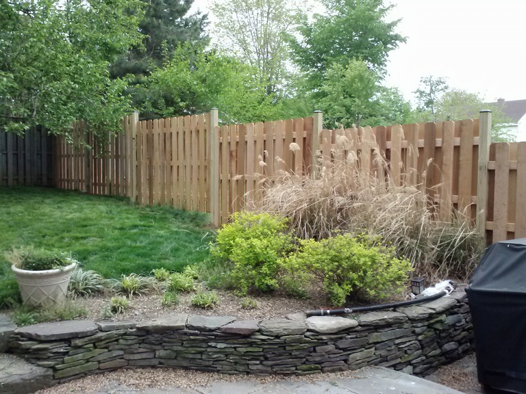 "Stockade" Style Alternating Board Fence without a Cap Board and Black Vinyl Post Caps