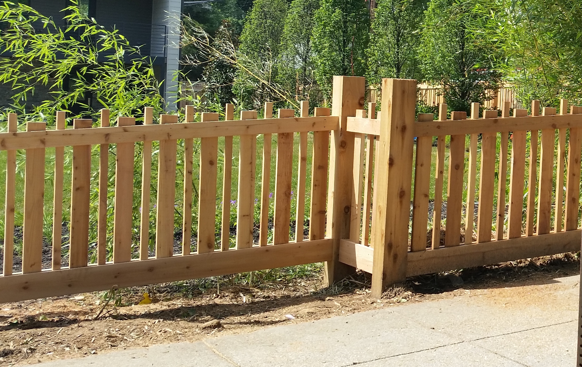 An Alternating Board Picket Fence in Western Red Cedar with Alternating Width Boards as well